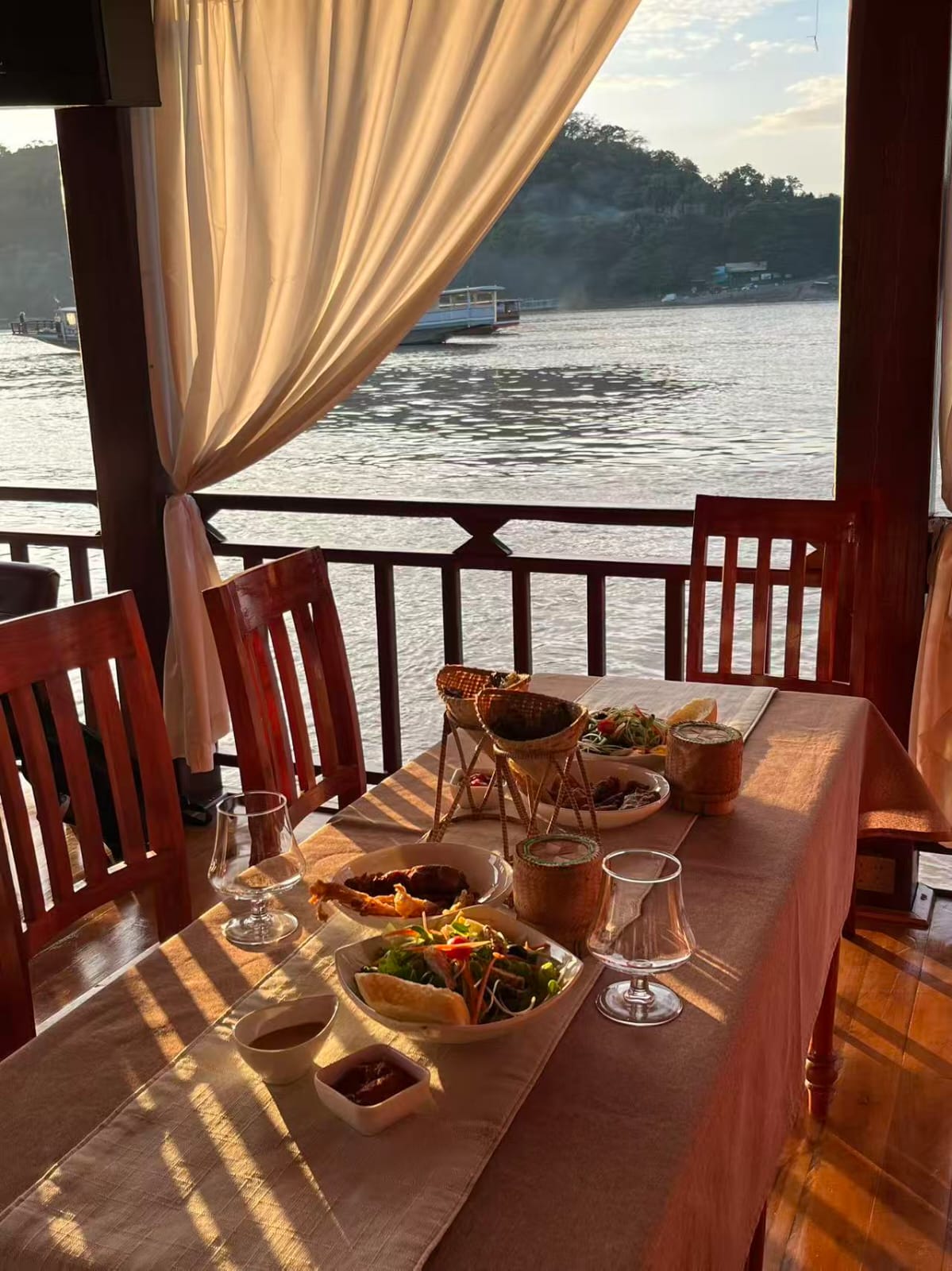 Food and drinks by a waterfront view on A One Cruise