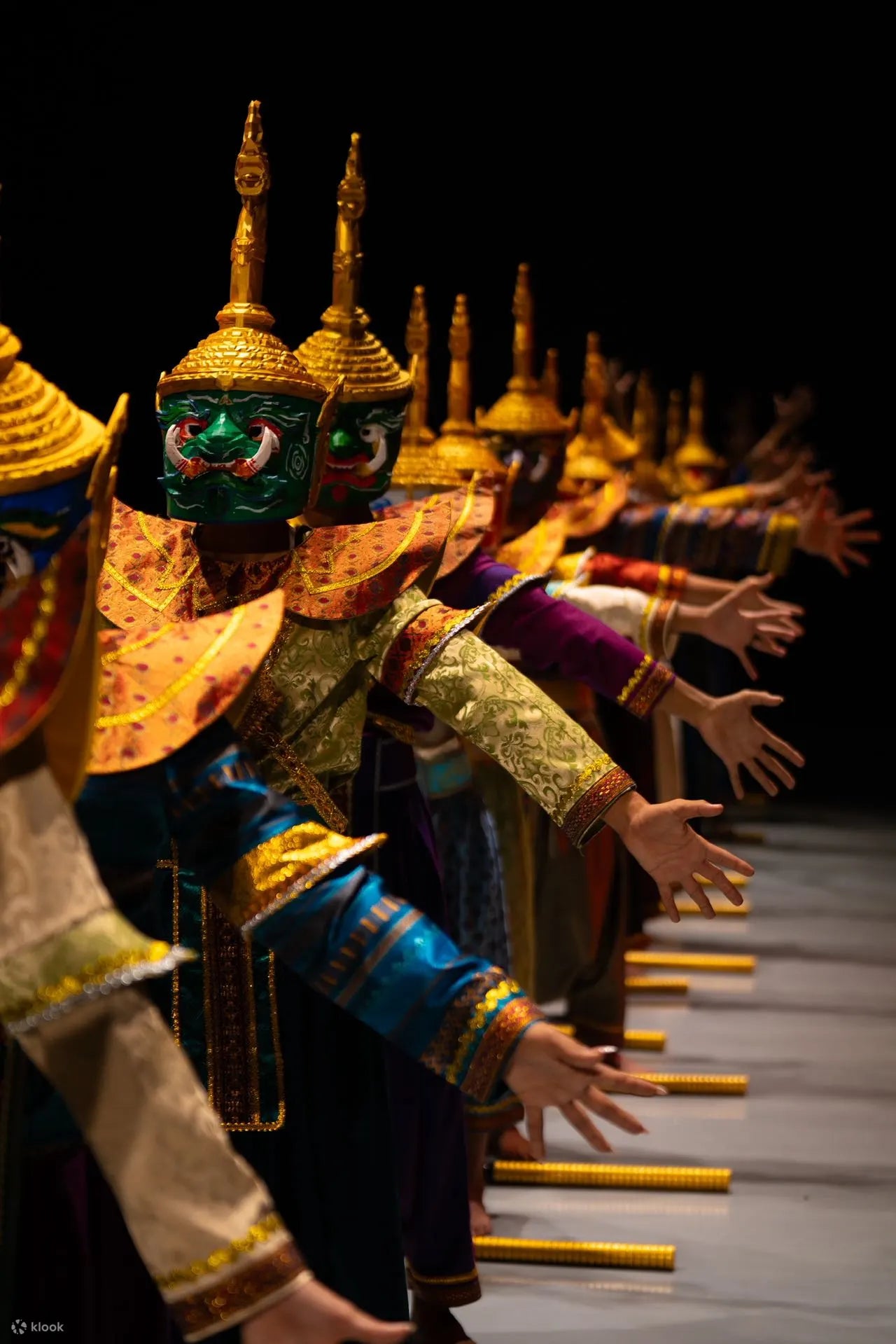 Traditional dancers in elaborate costumes on a stage